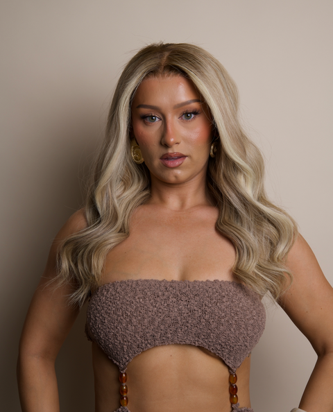 Woman wearing a textured brown bikini against a neutral background