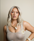 Woman wearing a sparkly top with decorative elements on a beige background