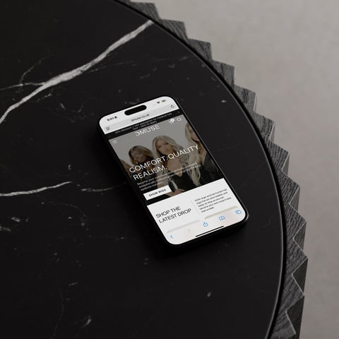 Smartphone displaying a website on a black marble surface