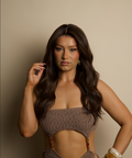 Woman wearing a brown dress against a beige background