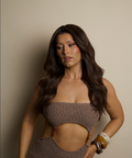 Woman wearing a brown textured top and pants against a beige background