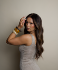 Woman in a silver dress posing against a plain background